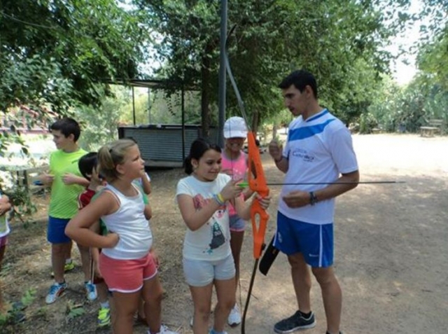  practicing archery among children 